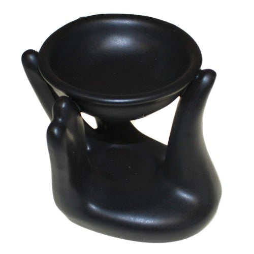 Close-up of black colour helping hand design ceramic oil burner showing smooth glaze finish and bowl for oil - Kraas