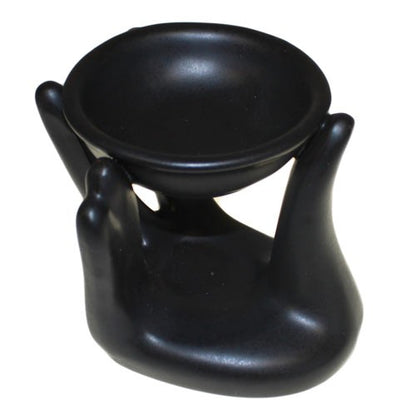 Close-up of black colour helping hand design ceramic oil burner showing smooth glaze finish and bowl for oil - Kraas