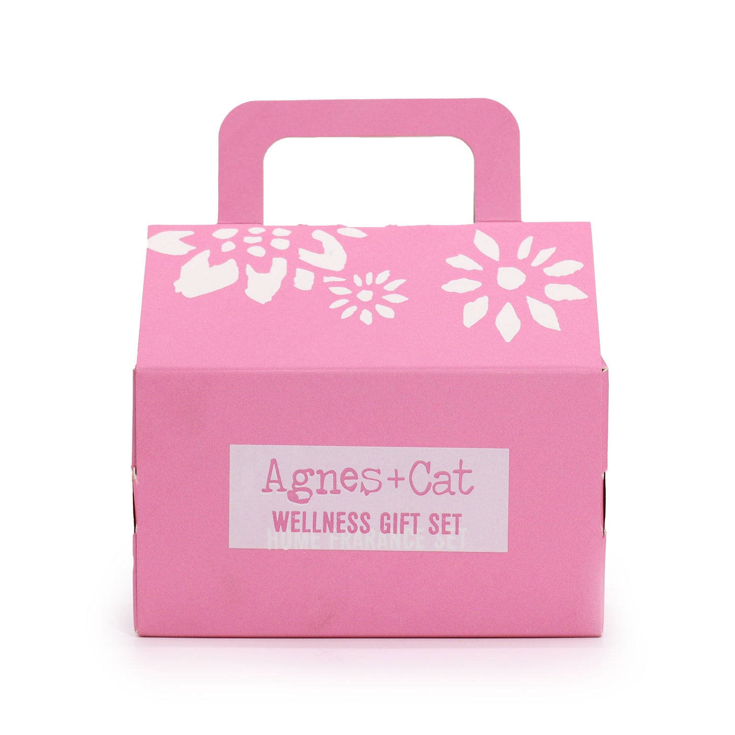 Pink gift box with white floral designs and 'Agnes + Cat Wellness Gift Set' label on a white background - Agnes and Cat
