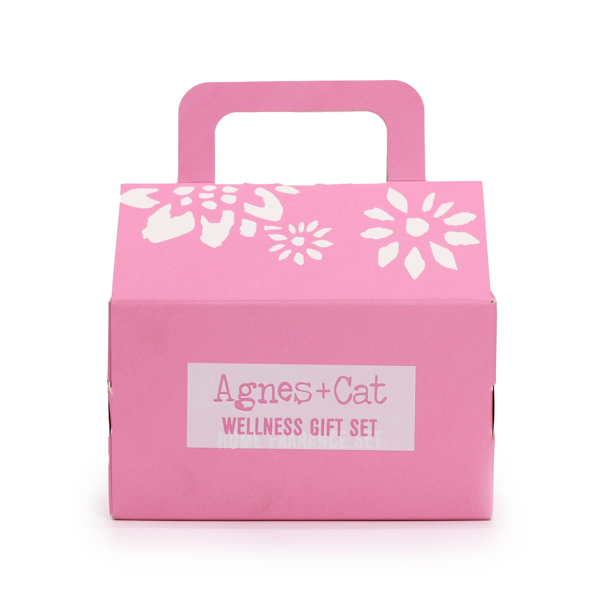 Pink gift box with white floral designs and 'Agnes + Cat Wellness Gift Set' label on a white background - Agnes and Cat