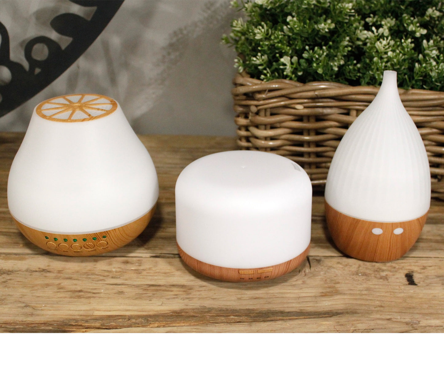 Three white portable essential oil diffuser The Atomiser for modern interiors on a wooden surface - Kraas