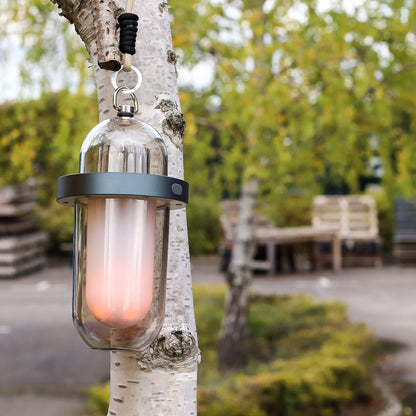 Portable hanging outdoor flame effect lamp adding ambient light to patio or garden décor