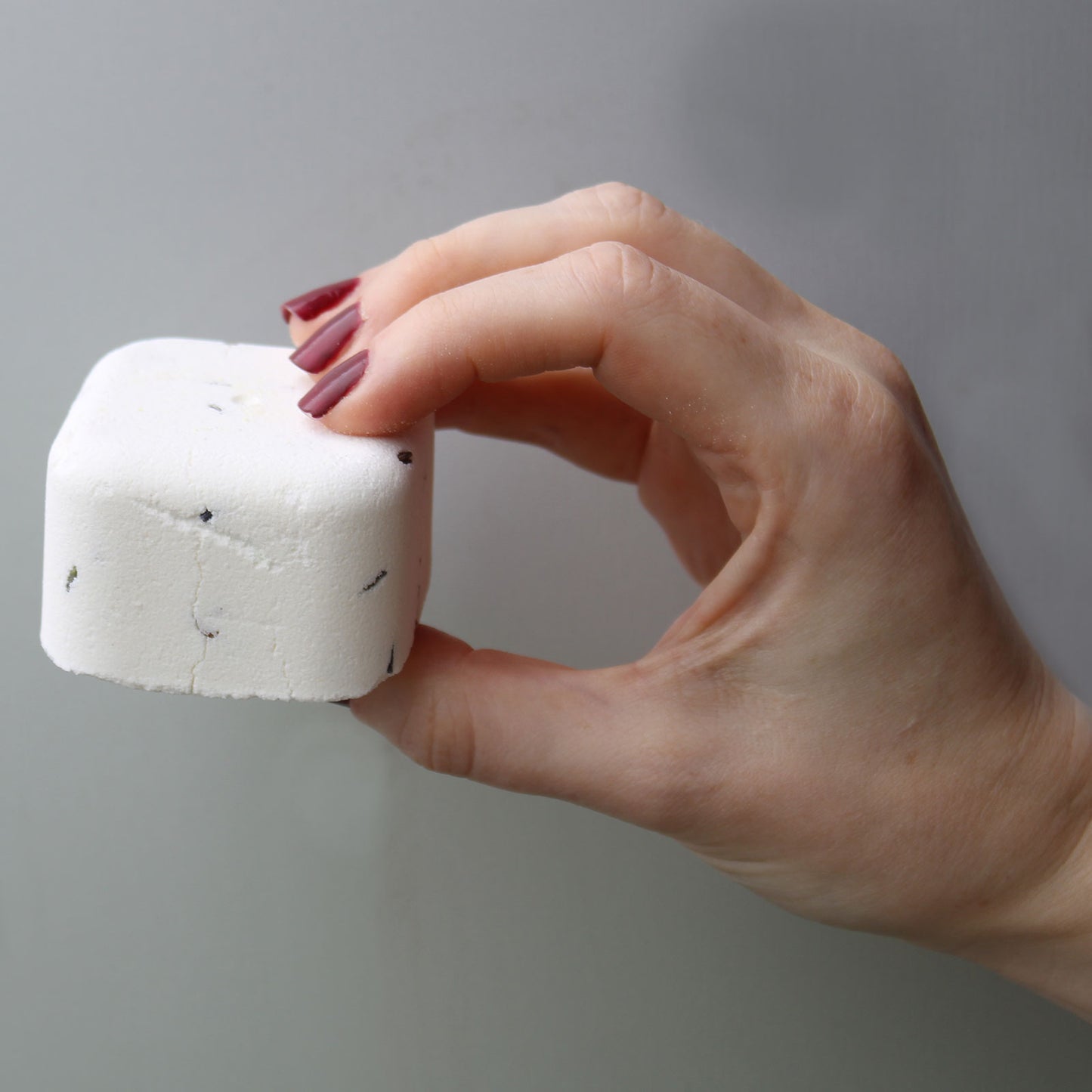 Girl hand holding deep sleep shower steamer - Kraas