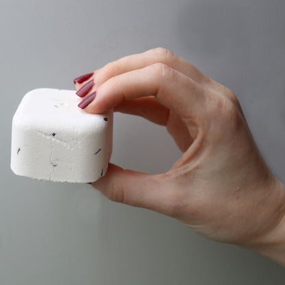 Girl hand holding deep sleep shower steamer - Kraas